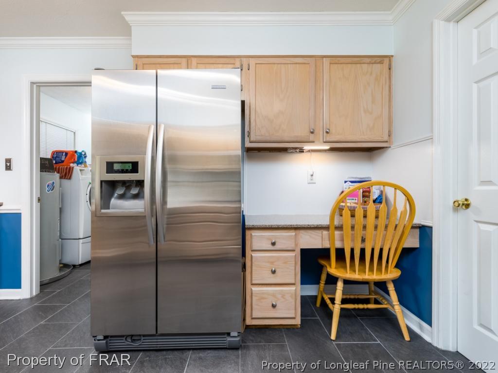 7790 Dragonhead Road Fayetteville, NC 28311 - Photo 17 of 36 a room with stainless steel appliances kitchen island granite countertop furniture and a refrigerator