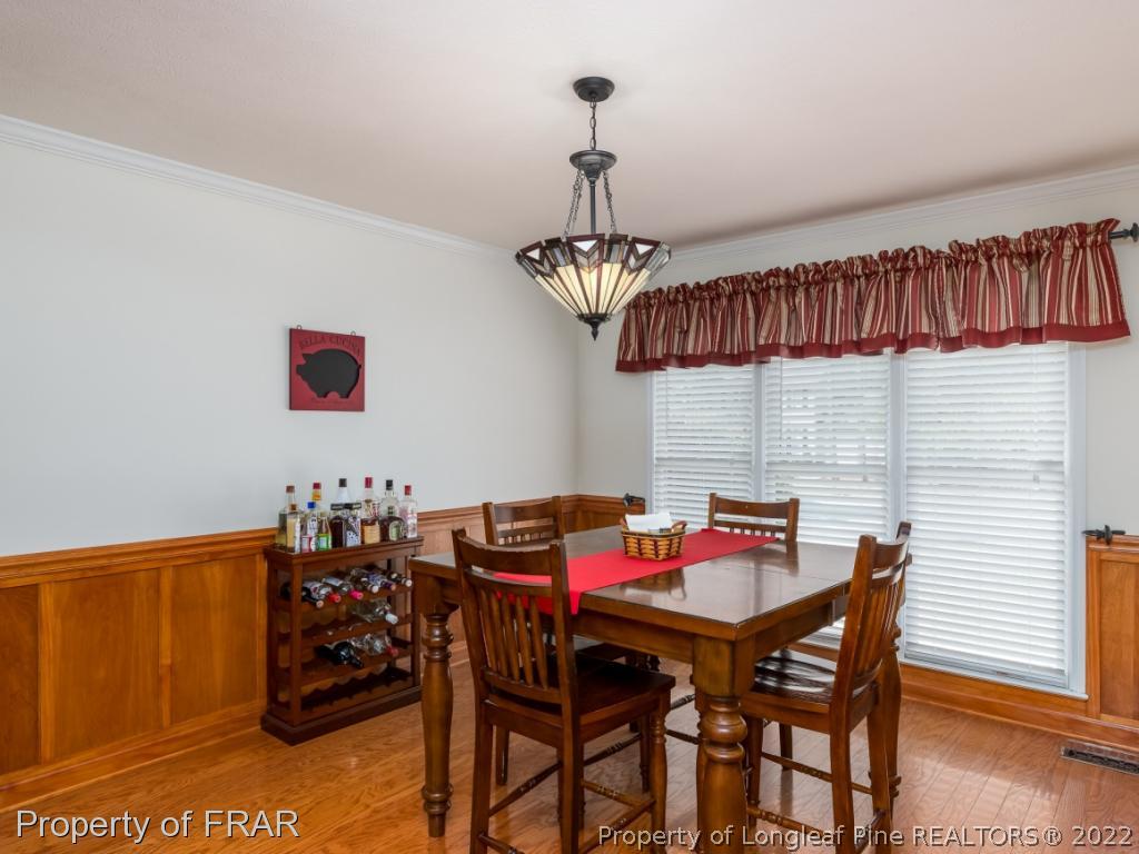 7790 Dragonhead Road Fayetteville, NC 28311 - Photo 22 of 36 a view of a dining room with furniture and chandelier