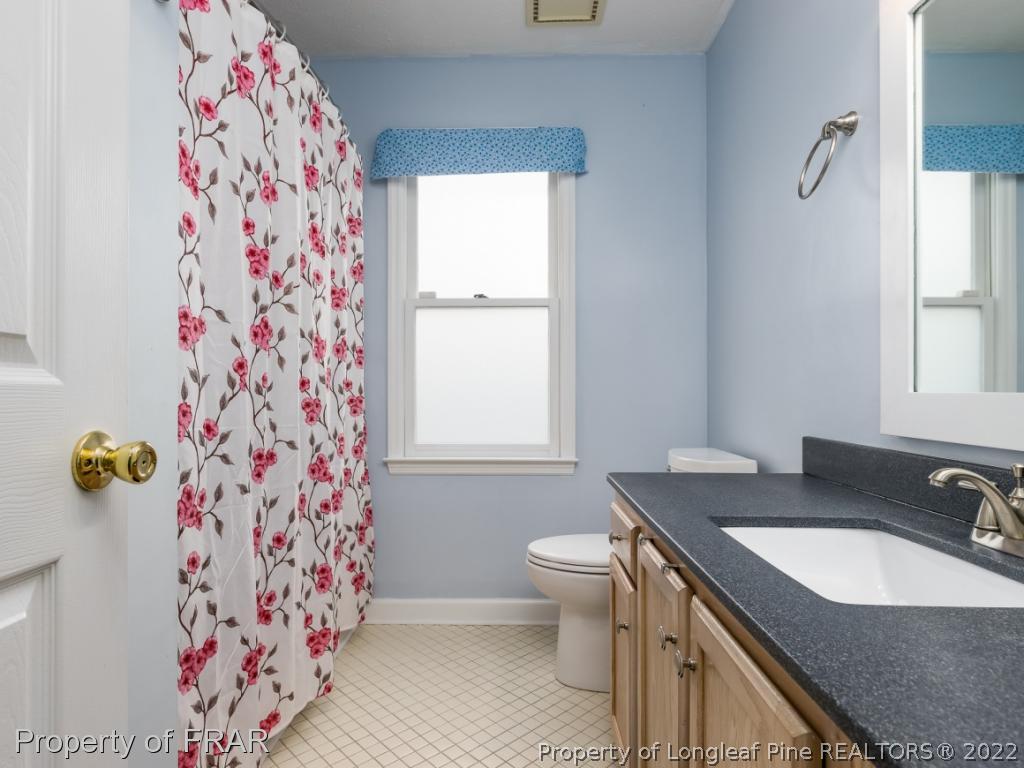 7790 Dragonhead Road Fayetteville, NC 28311 - Photo 24 of 36 a bathroom with a sink toilet and window