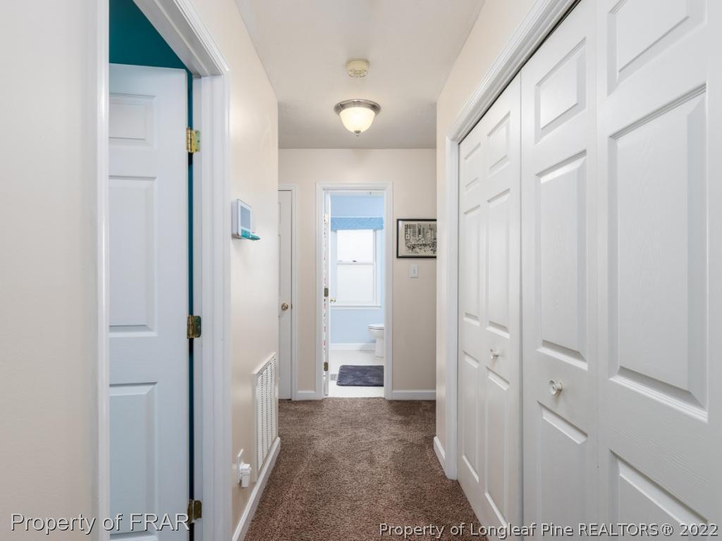 7790 Dragonhead Road Fayetteville, NC 28311 - Photo 25 of 36 a view of a hallway with a livingroom and a bathroom