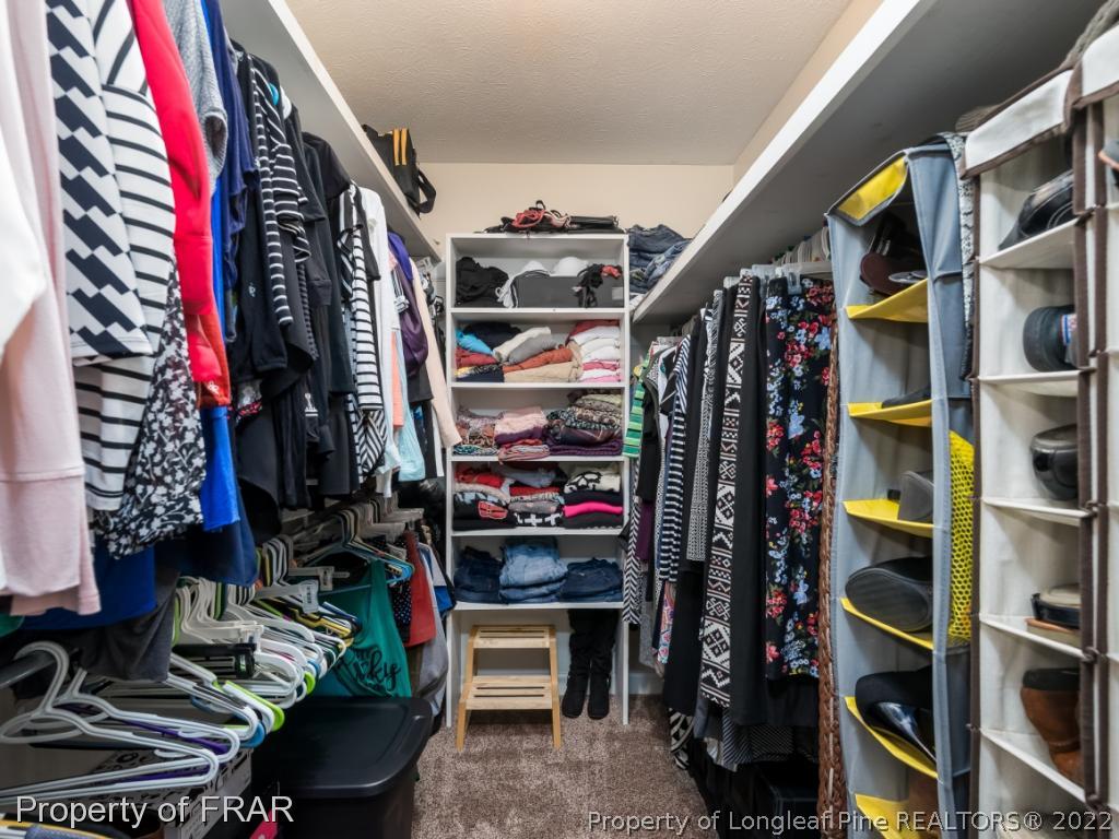 7790 Dragonhead Road Fayetteville, NC 28311 - Photo 29 of 36 a view of walk in closet with clothes and shoes