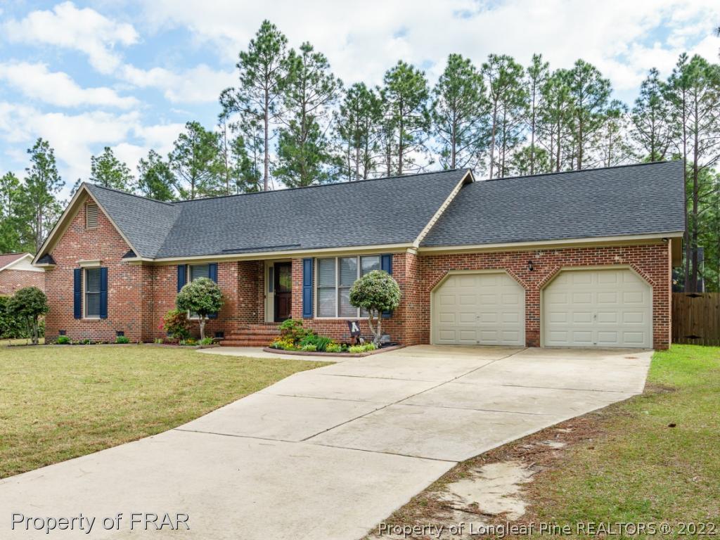 7790 Dragonhead Road Fayetteville, NC 28311 - Photo 3 of 36 a front view of a house with a yard and garage