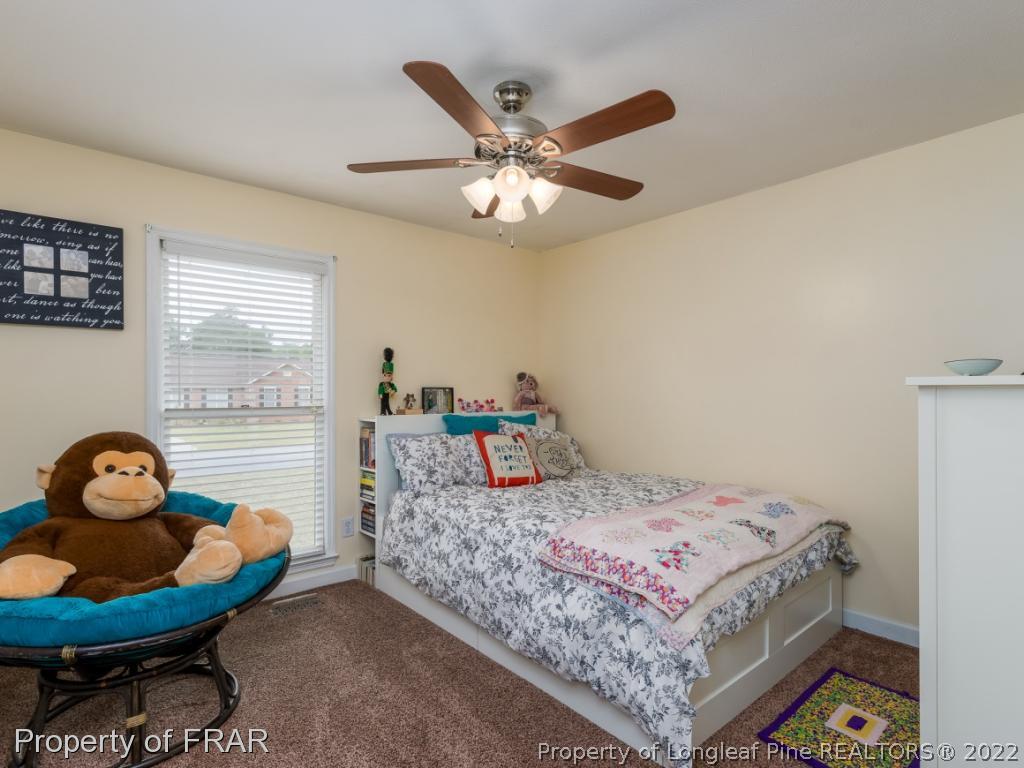 7790 Dragonhead Road Fayetteville, NC 28311 - Photo 33 of 36 a bedroom with a bed and ceiling fan