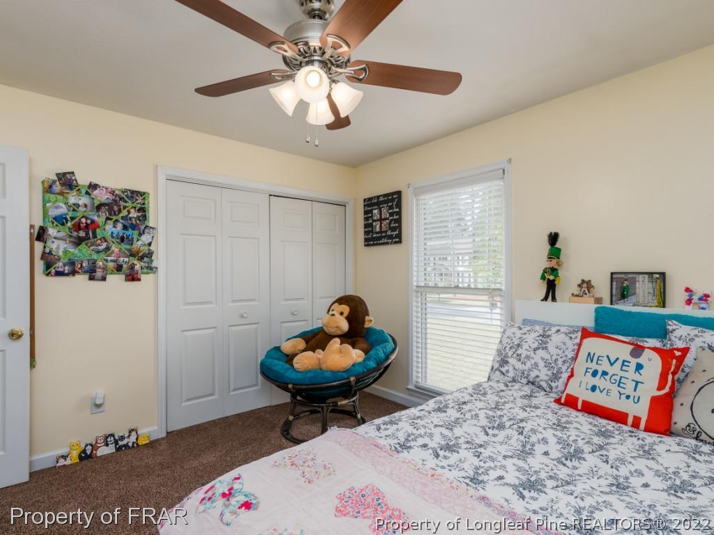 7790 Dragonhead Road Fayetteville, NC 28311 - Photo 34 of 36 a living room with baby crib furniture and a table