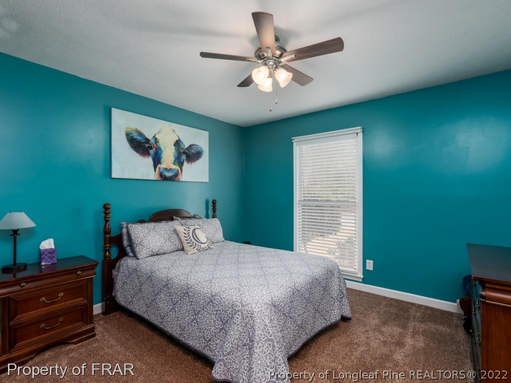 7790 Dragonhead Road Fayetteville, NC 28311 - Photo 35 of 36 a bedroom with a bed and a window