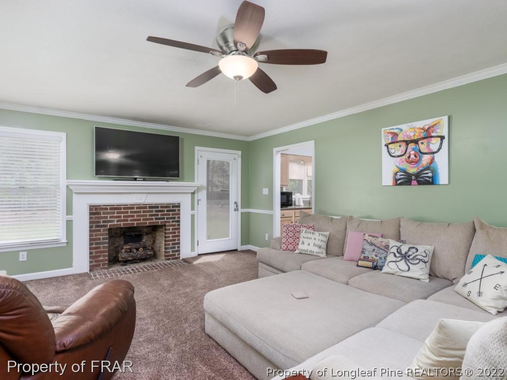 7790 Dragonhead Road Fayetteville, NC 28311 - Photo 10 of 36 a living room with furniture and a fireplace