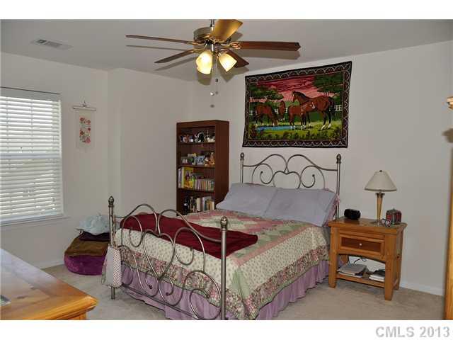 205 Lind Point Lane Monroe, NC 28110 - Photo 12 of 16 a bedroom with furniture and a flat screen tv