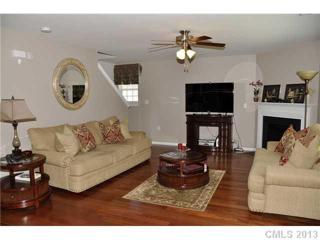 205 Lind Point Lane Monroe, NC 28110 - Photo 4 of 16 a living room with furniture a flat screen tv and a fireplace