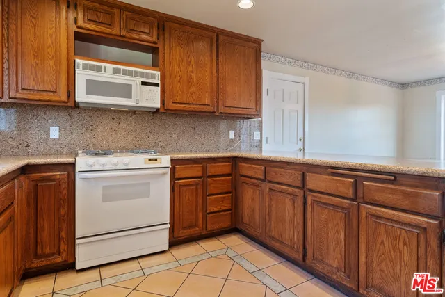 a view of a dining room with furniture a chandelier and wooden floor