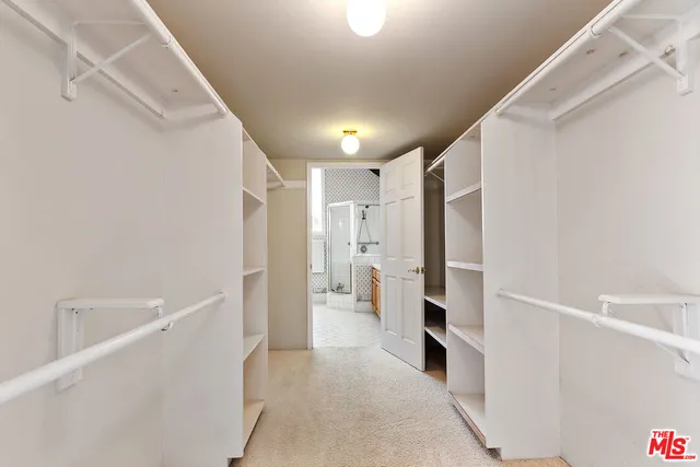 a bathroom with a double vanity sink a toilet and shower