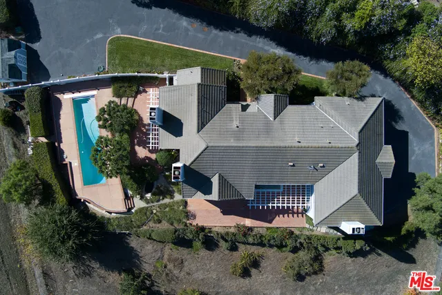 a living room with furniture fireplace and a large window
