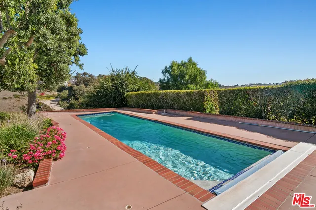 a kitchen with stainless steel appliances granite countertop white cabinets window and sink
