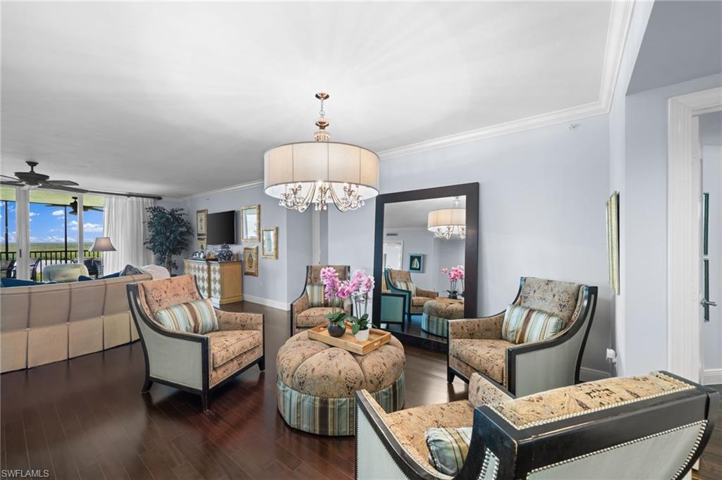 1050 Borghese Lane, Unit 902 Naples, FL 34114 - Photo 14 of 50 Living room with ceiling fan with notable chandelier, dark hardwood / wood-style flooring, and ornamental molding