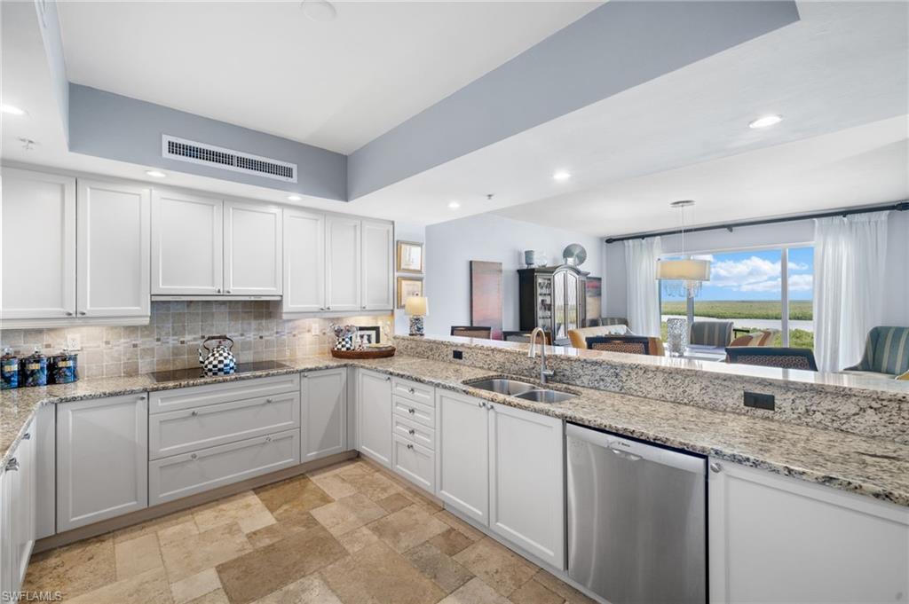 1050 Borghese Lane, Unit 902 Naples, FL 34114 - Photo 18 of 50 Kitchen with black electric stovetop, dishwasher, white cabinetry, and sink