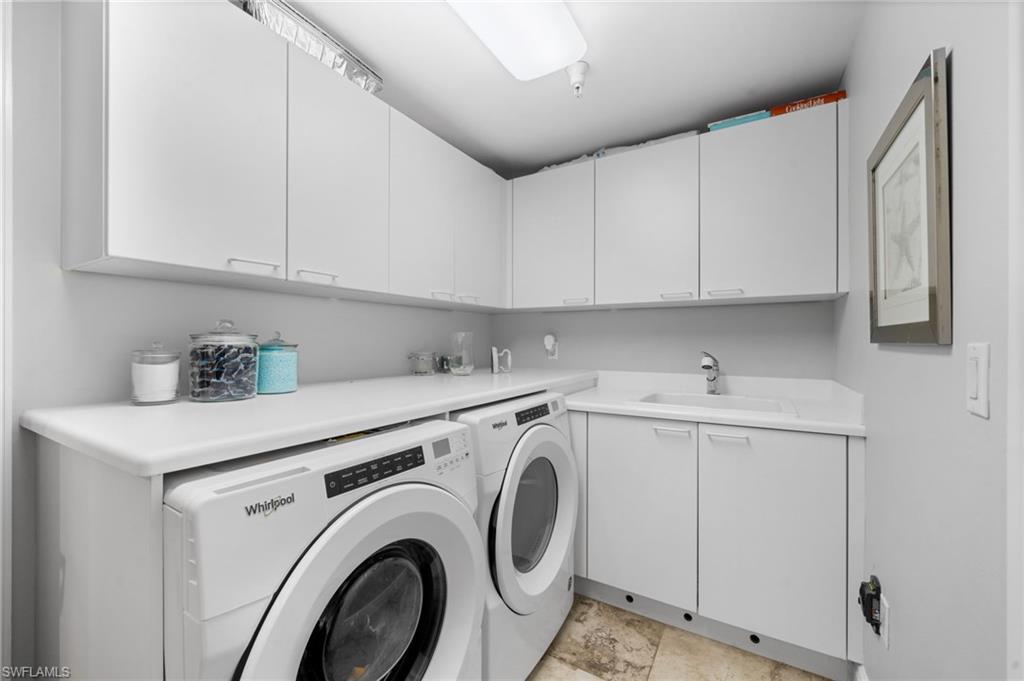 1050 Borghese Lane, Unit 902 Naples, FL 34114 - Photo 25 of 50 Laundry area with cabinets, washer and clothes dryer, and sink