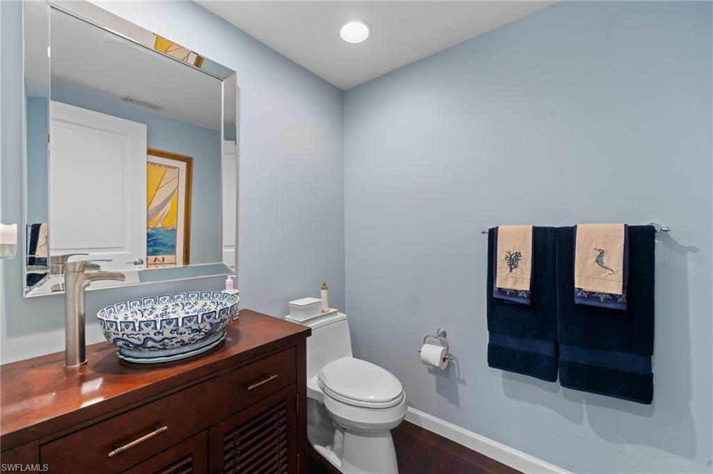 1050 Borghese Lane, Unit 902 Naples, FL 34114 - Photo 26 of 50 Bathroom with vanity, toilet, and wood-type flooring