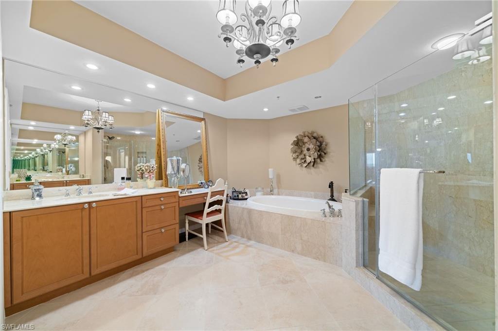 1050 Borghese Lane, Unit 902 Naples, FL 34114 - Photo 31 of 50 Bathroom with vanity, a notable chandelier, and plus walk in shower