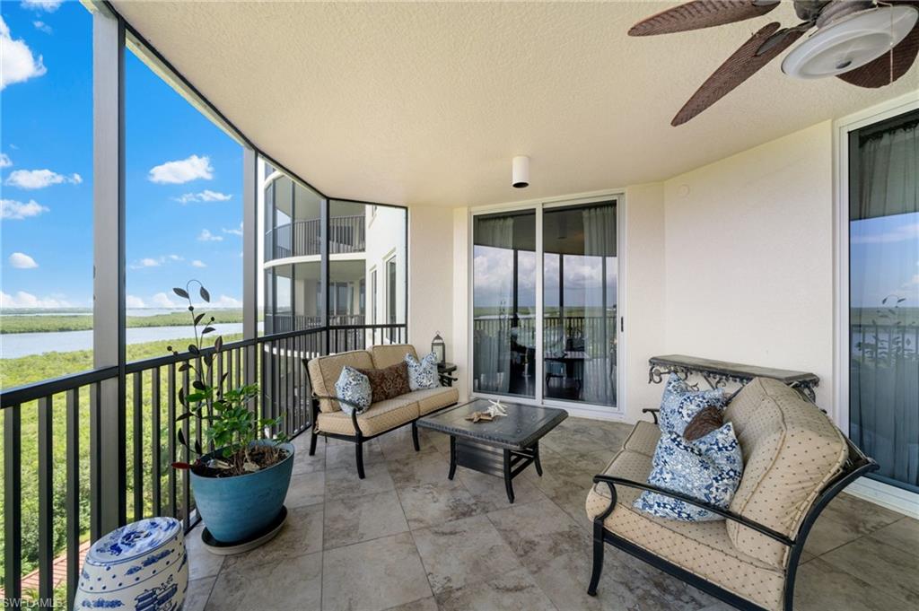 1050 Borghese Lane, Unit 902 Naples, FL 34114 - Photo 6 of 50 Sunroom / solarium featuring ceiling fan and a water view