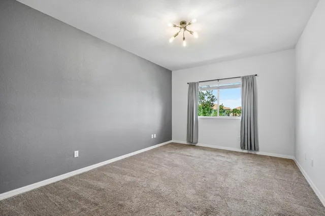 a view of an empty room and a window