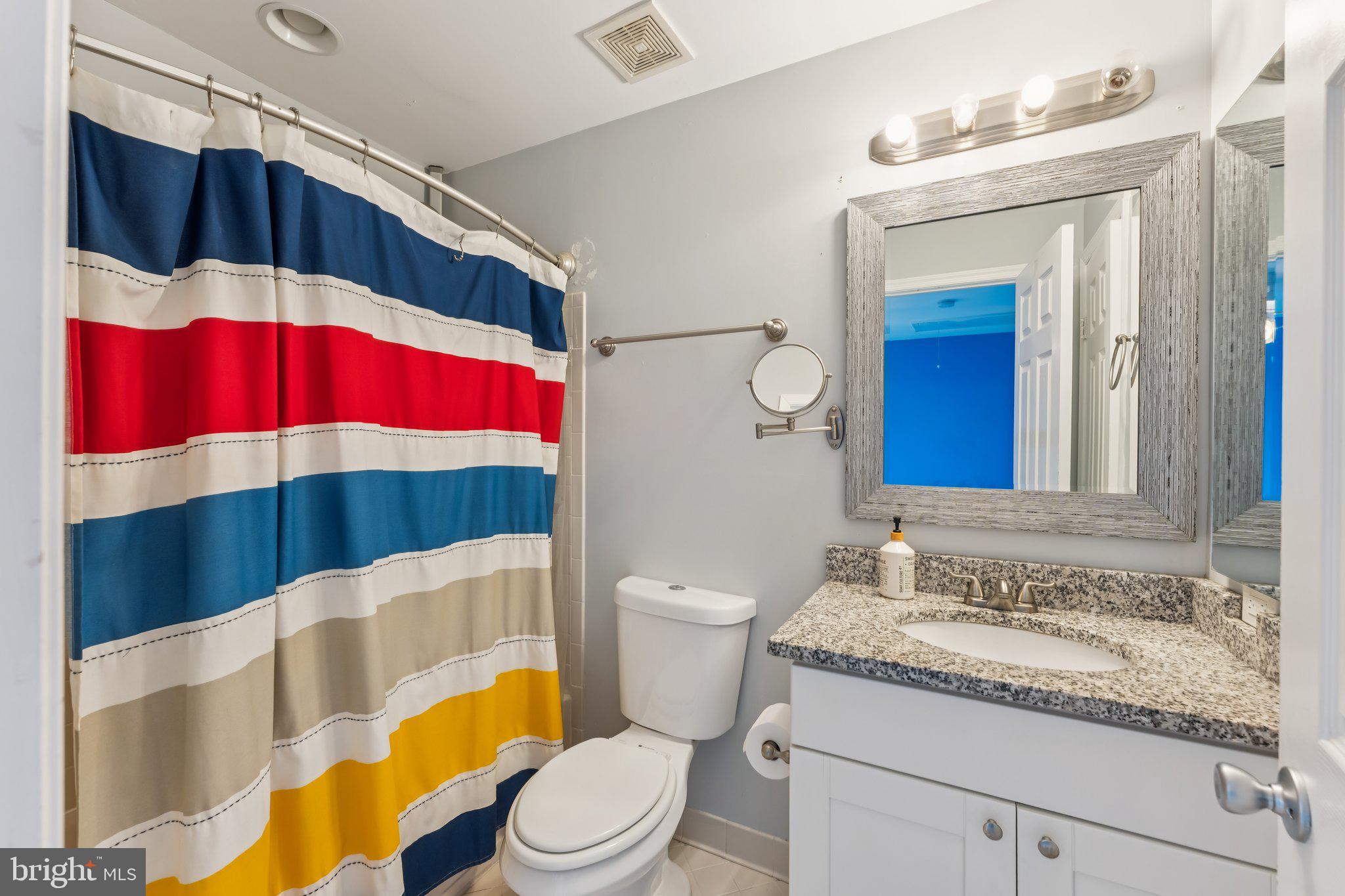 14520 Fairdale Road Silver Spring, MD 20905 - Photo 27 of 50 a bathroom with a sink a toilet and shower curtain