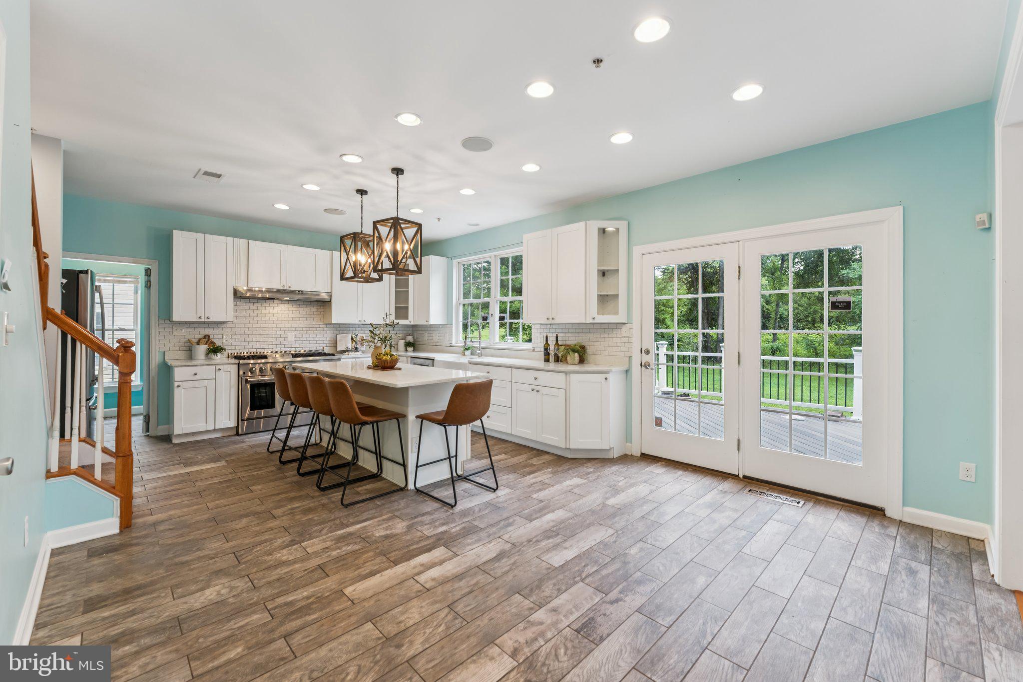 14520 Fairdale Road Silver Spring, MD 20905 - Photo 3 of 50 a kitchen with stainless steel appliances kitchen island granite countertop a stove a refrigerator and a wooden cabinets