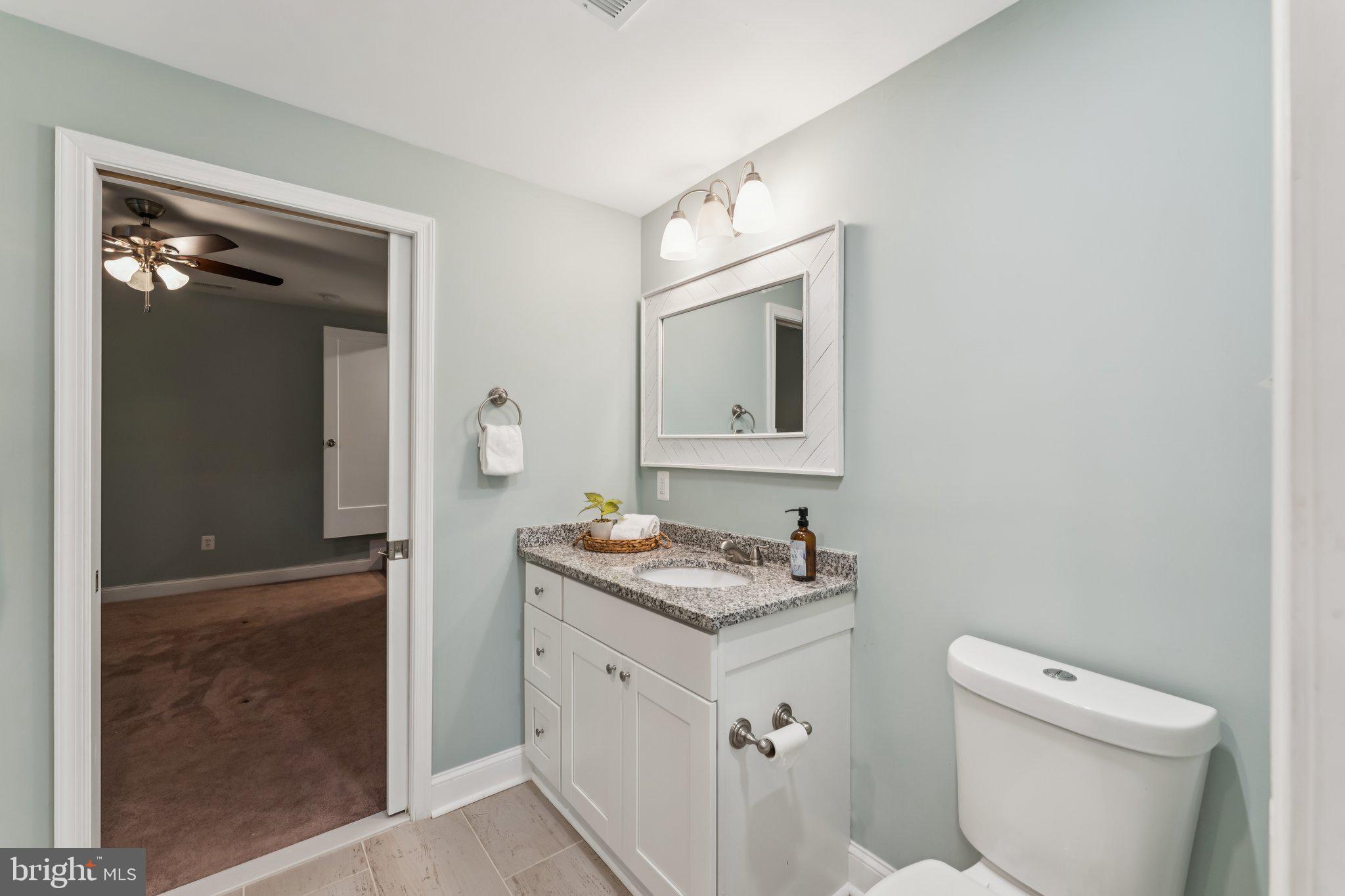 14520 Fairdale Road Silver Spring, MD 20905 - Photo 38 of 50 a bathroom with a toilet sink and mirror