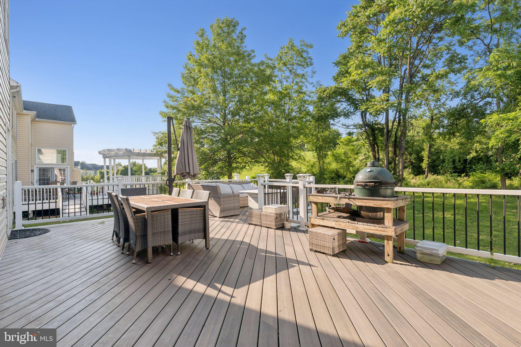 14520 Fairdale Road Silver Spring, MD 20905 - Photo 42 of 50 a view of a deck with table and chairs a barbeque with wooden floor and fence