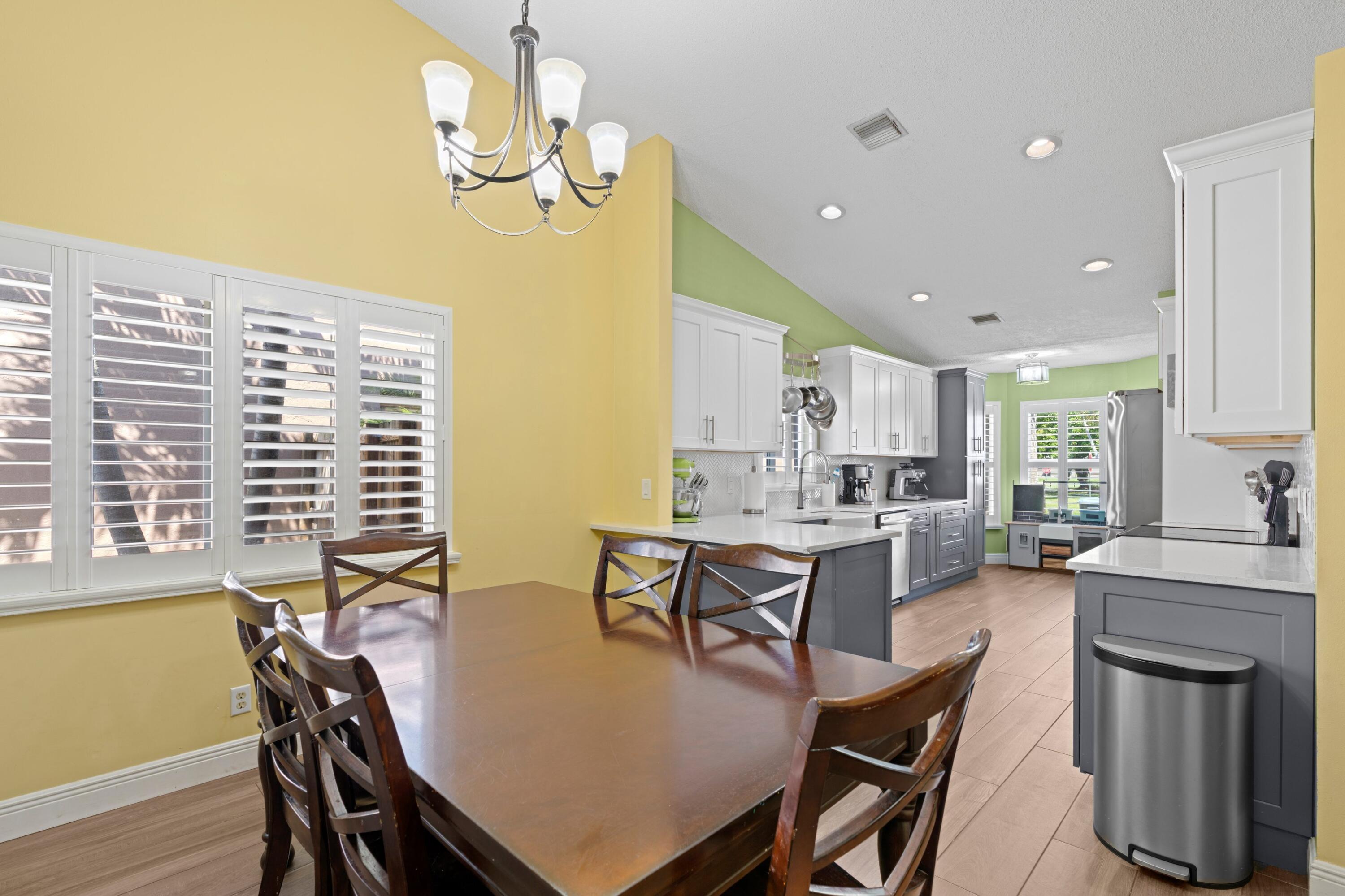 8584 Shawe Way Boca Raton, FL 33433 - Photo 11 of 43 a view of a dining room with furniture window and wooden floor