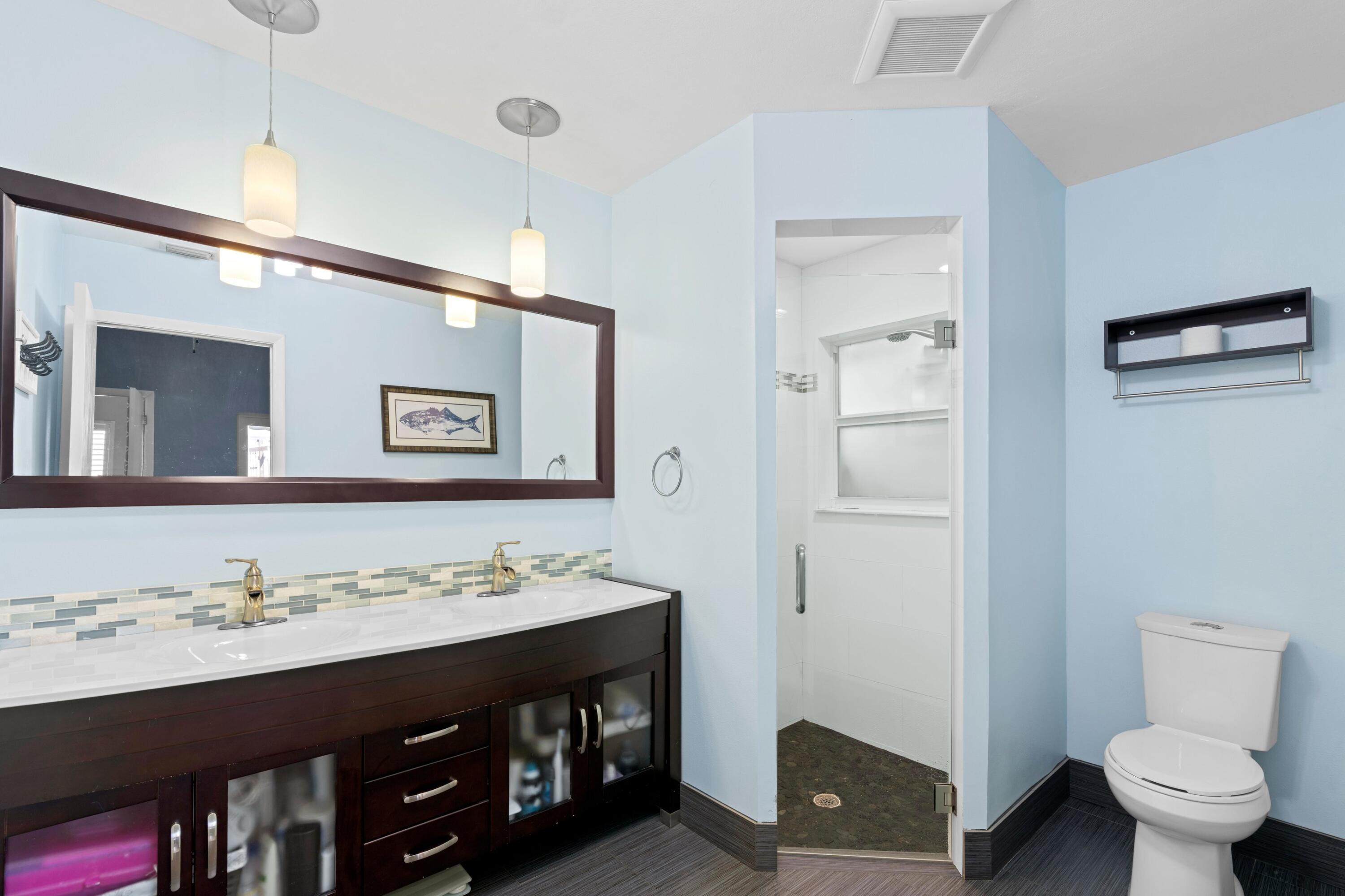 8584 Shawe Way Boca Raton, FL 33433 - Photo 13 of 43 a bathroom with a sink a toilet and a mirror
