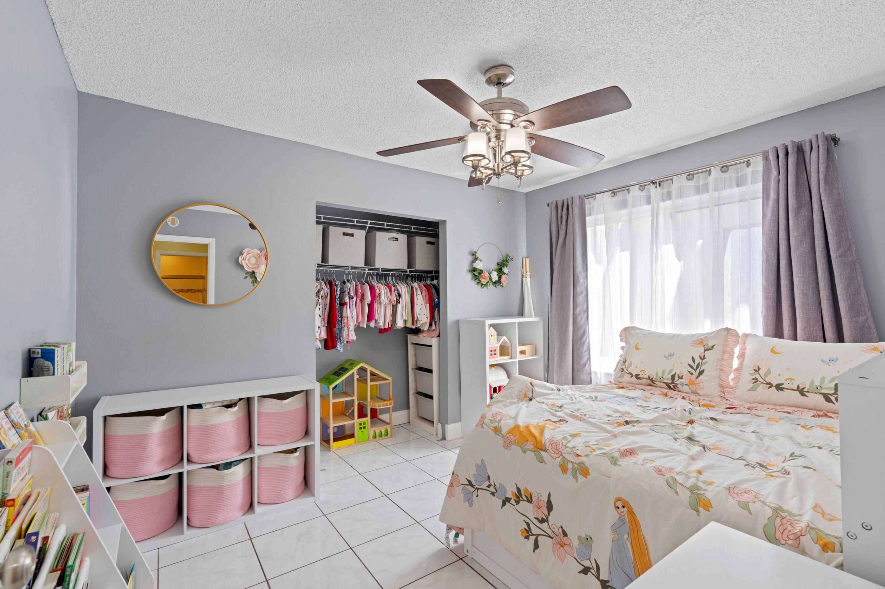 8584 Shawe Way Boca Raton, FL 33433 - Photo 14 of 43 a bedroom with a bed and a chandelier