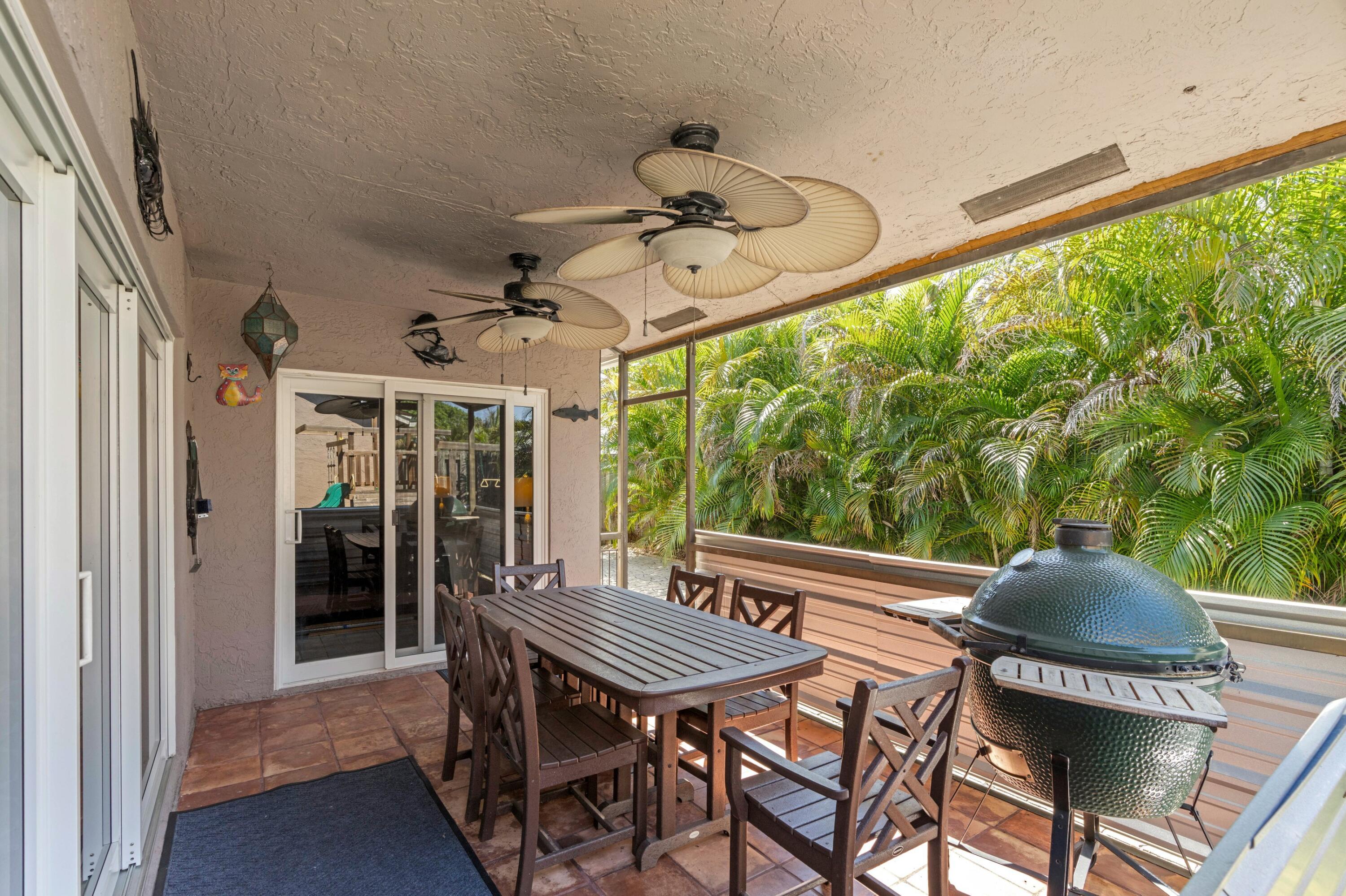 8584 Shawe Way Boca Raton, FL 33433 - Photo 17 of 43 a view of a patio with a table chairs and a yard
