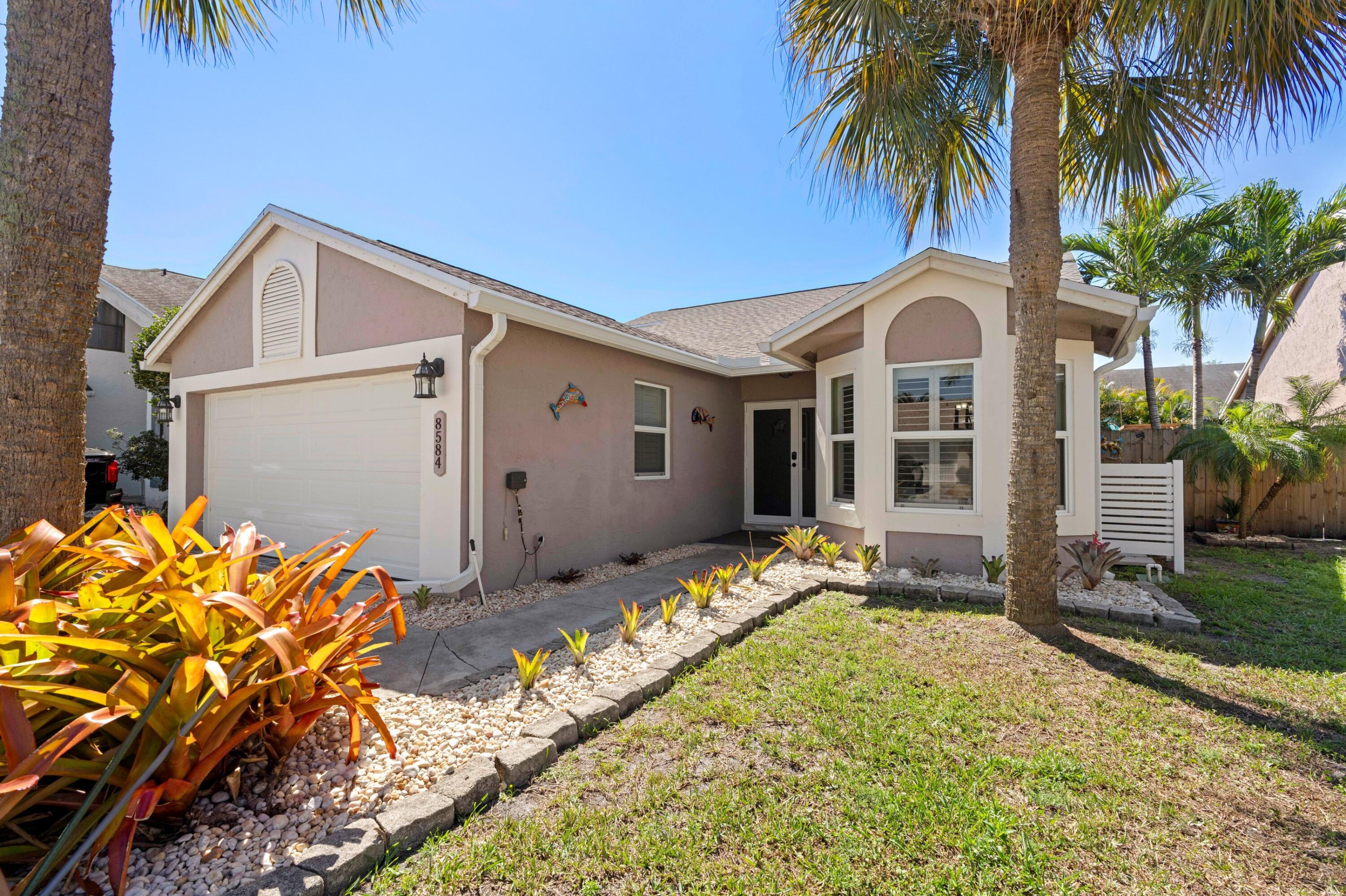 8584 Shawe Way Boca Raton, FL 33433 - Photo 23 of 43 a front view of house with yard outdoor seating and barbeque oven