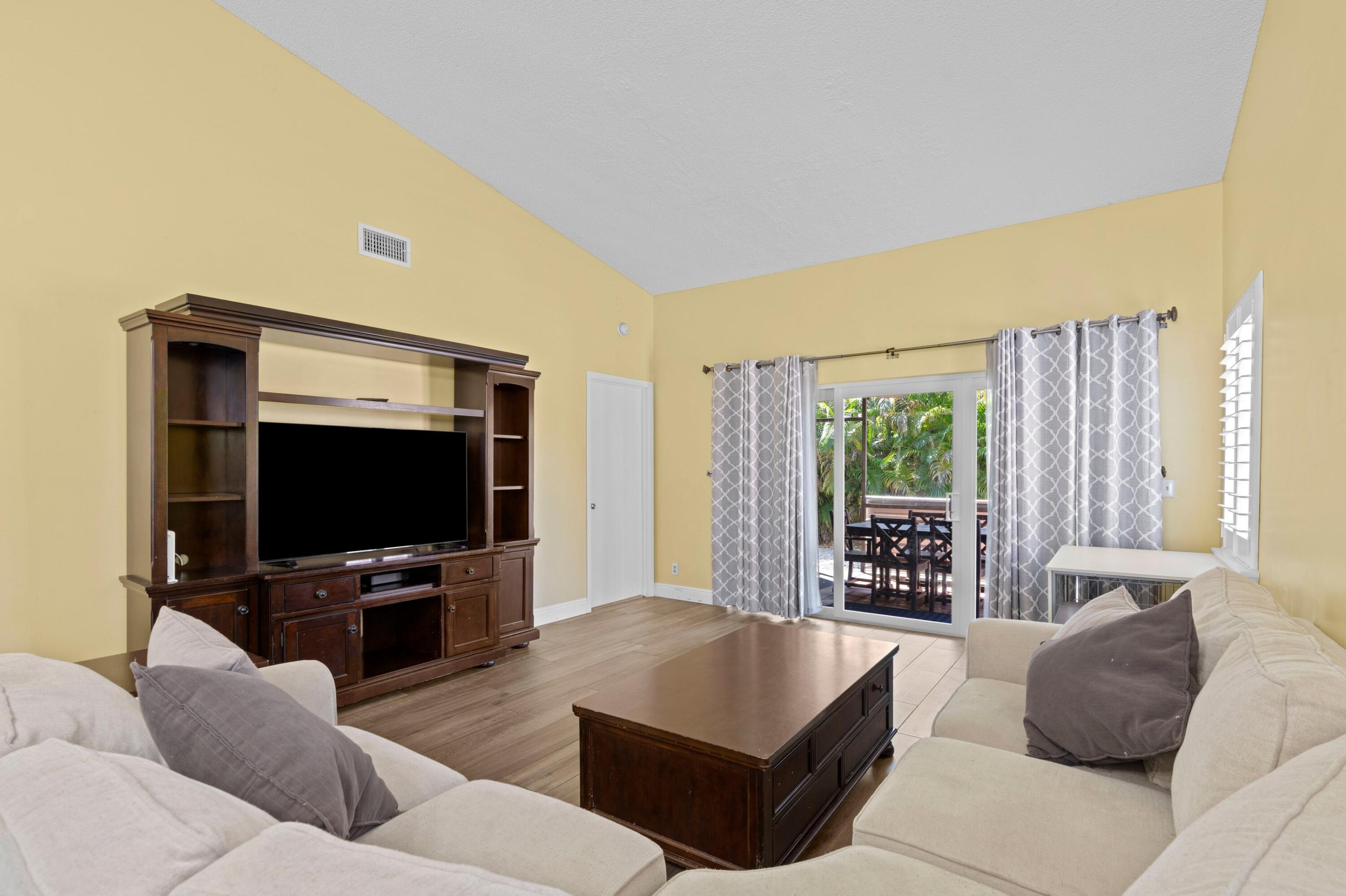 8584 Shawe Way Boca Raton, FL 33433 - Photo 4 of 43 a living room with furniture and a flat screen tv