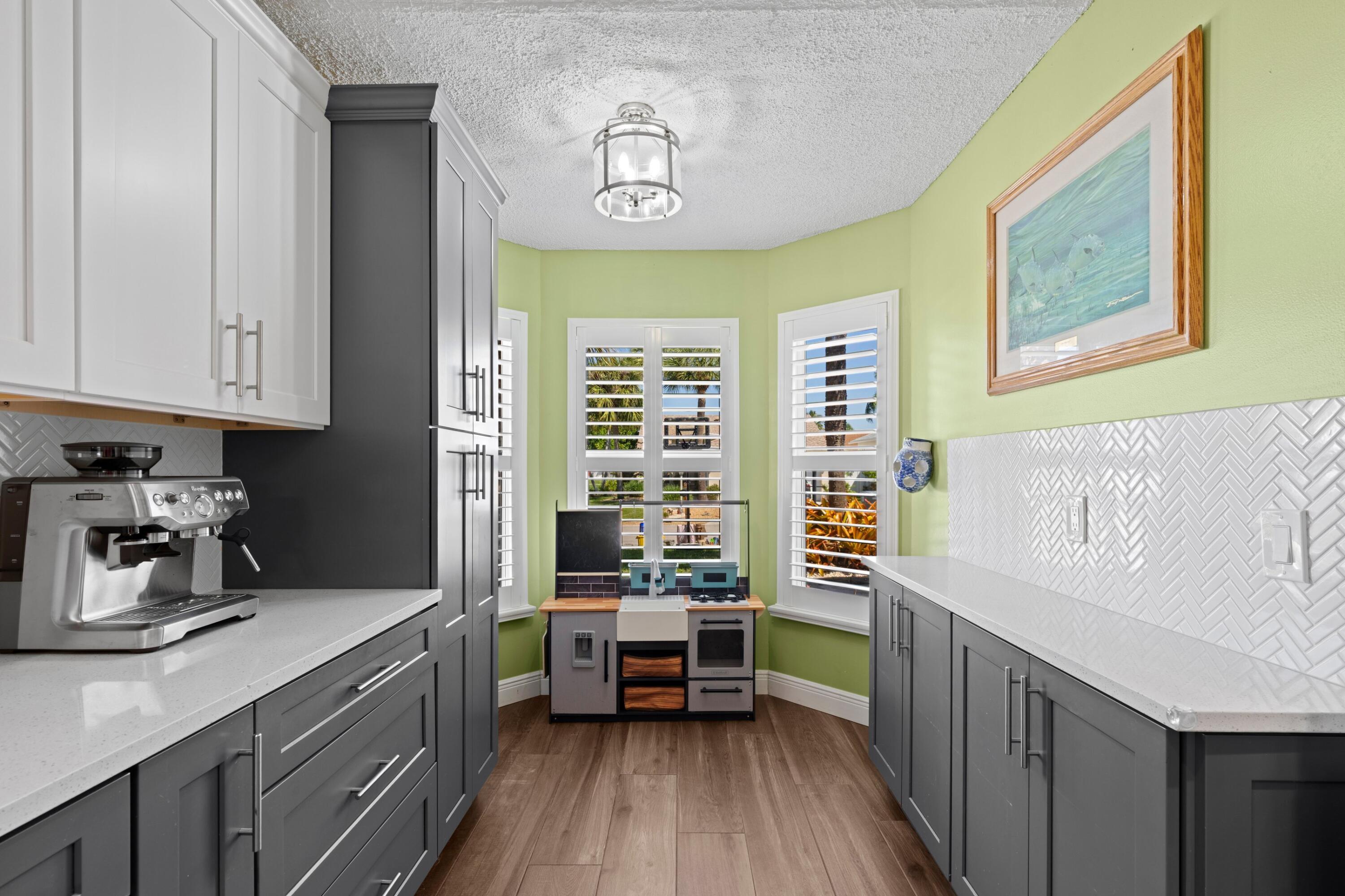 8584 Shawe Way Boca Raton, FL 33433 - Photo 9 of 43 a kitchen with a refrigerator a sink and wooden cabinets