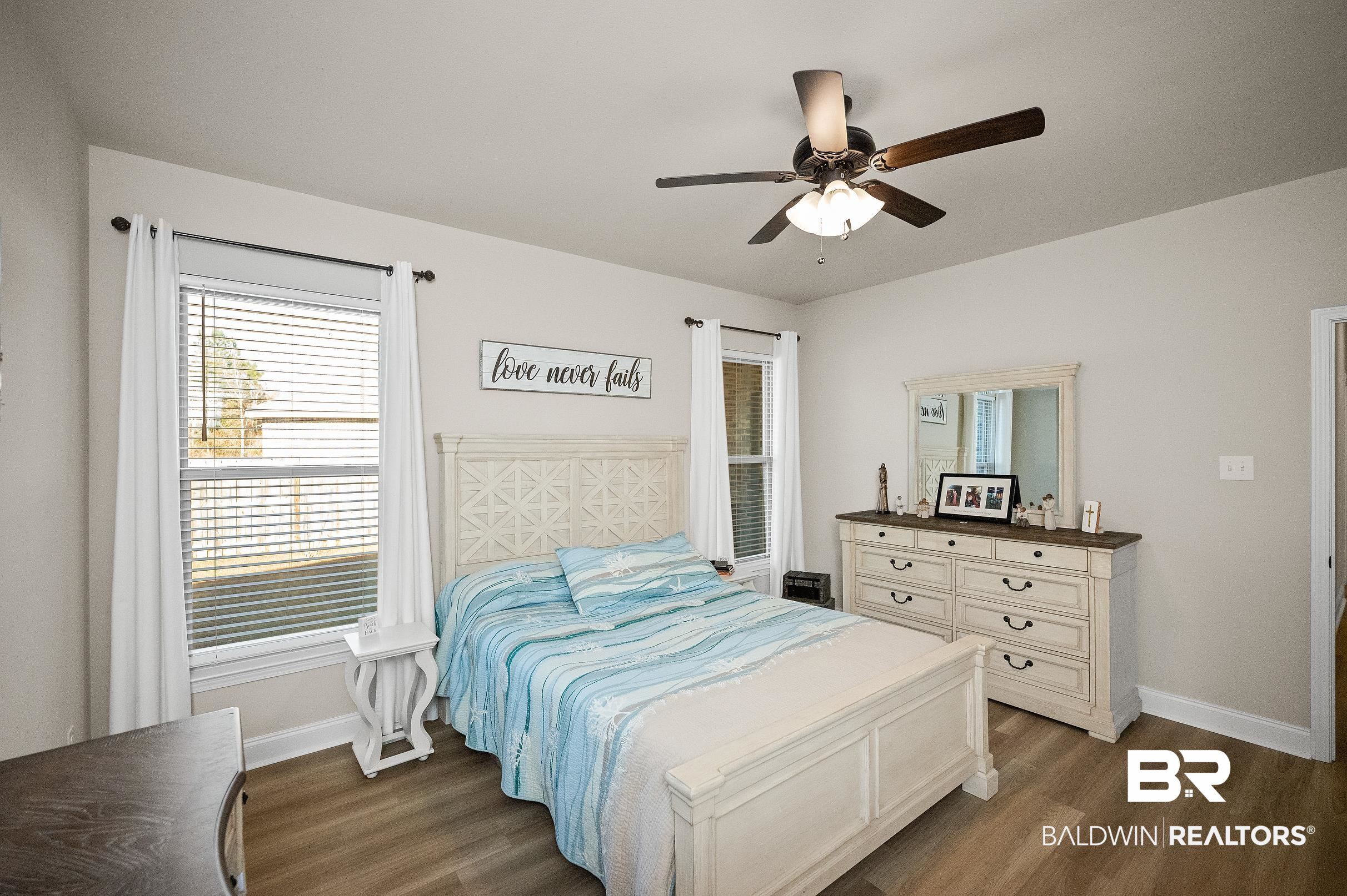 1077 Stella Road Foley, AL 36535 - Photo 19 of 27 Bedroom with dark wood-style floors and ceiling fan