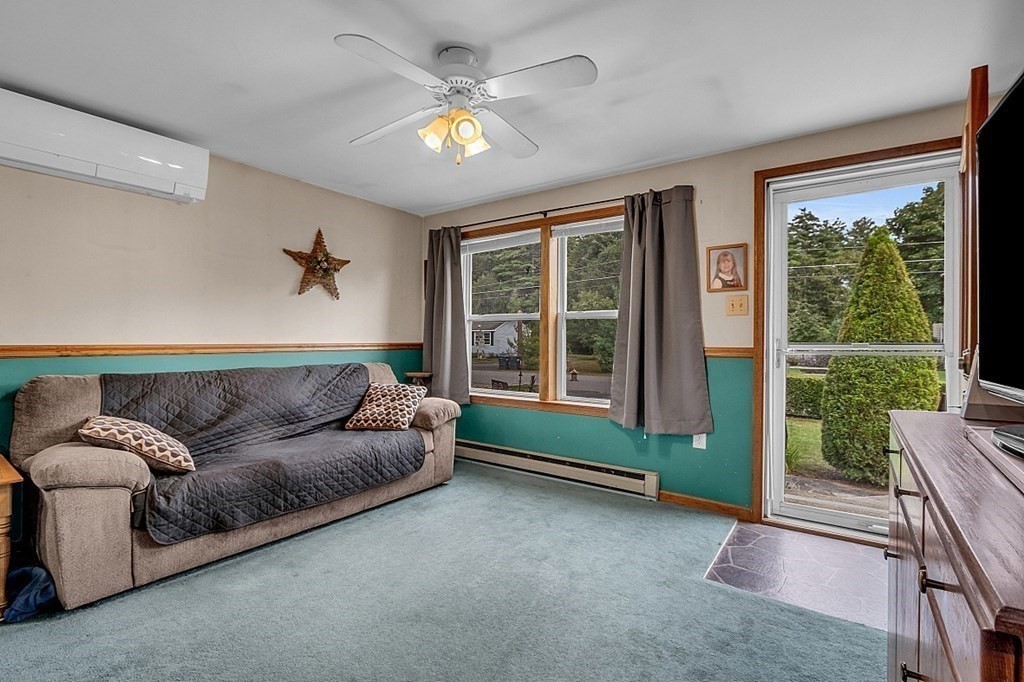173 Memory Lane Orange, MA 01364 - Photo 15 of 28 a living room with furniture and a large window