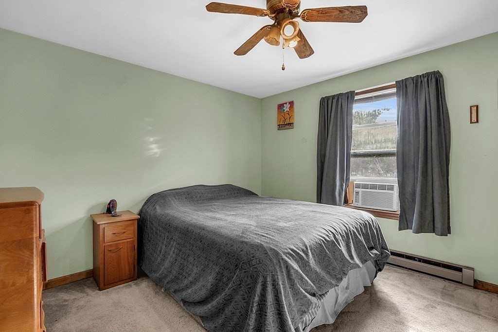 173 Memory Lane Orange, MA 01364 - Photo 20 of 28 a bedroom with a bed and window
