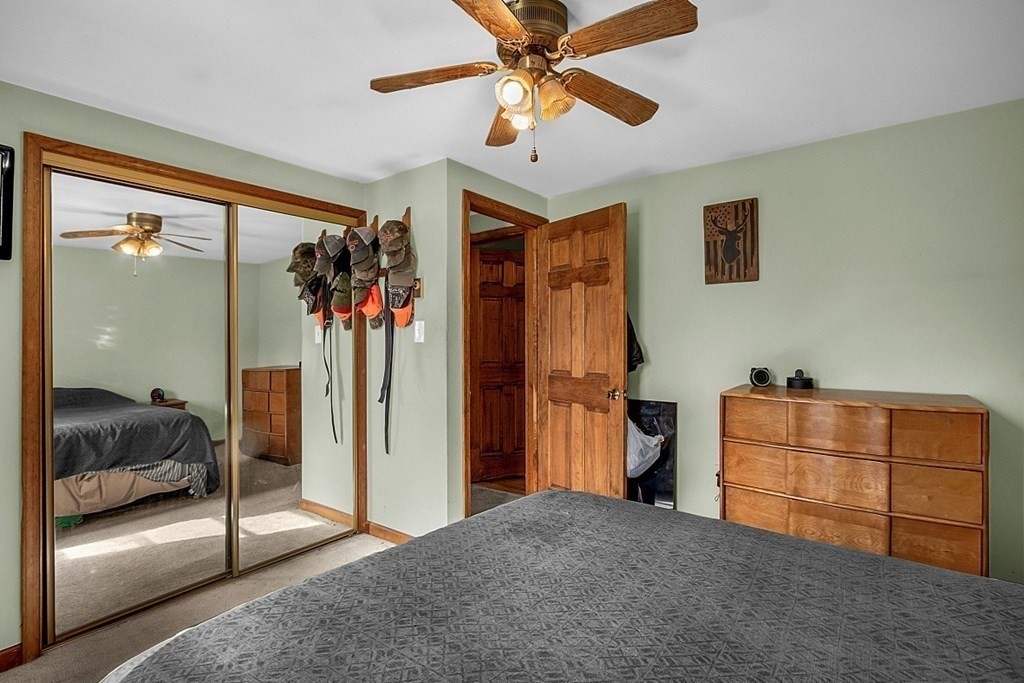 173 Memory Lane Orange, MA 01364 - Photo 21 of 28 a bedroom with furniture and a walk in closet