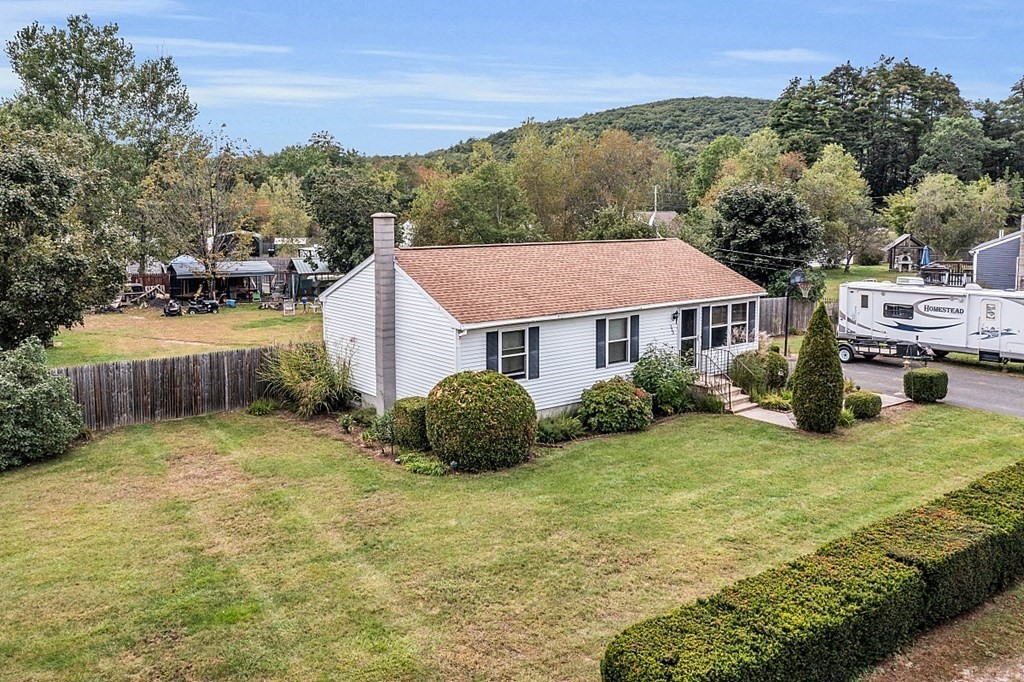 173 Memory Lane Orange, MA 01364 - Photo 3 of 28 a aerial view of a house next to a yard