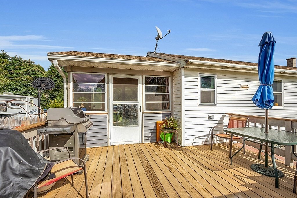 173 Memory Lane Orange, MA 01364 - Photo 7 of 28 a view of a patio with table and chairs and wooden floor