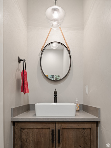 641 West 500 South Midway, UT 84049 - Photo 21 of 52 Modern vanity featuring a vessel sink, dark wood-finish cabinetry, and a stone countertop