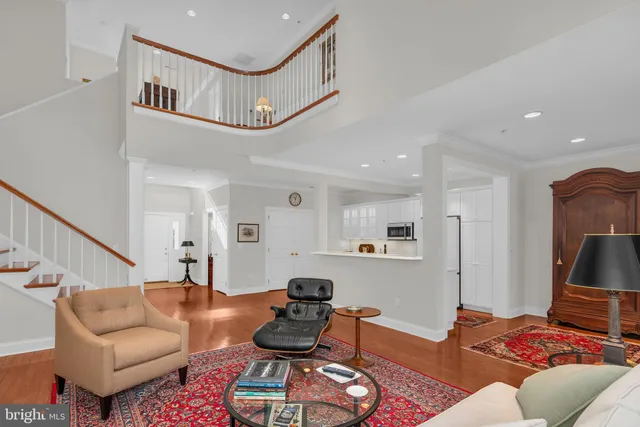 a living room with furniture and a view of kitchen