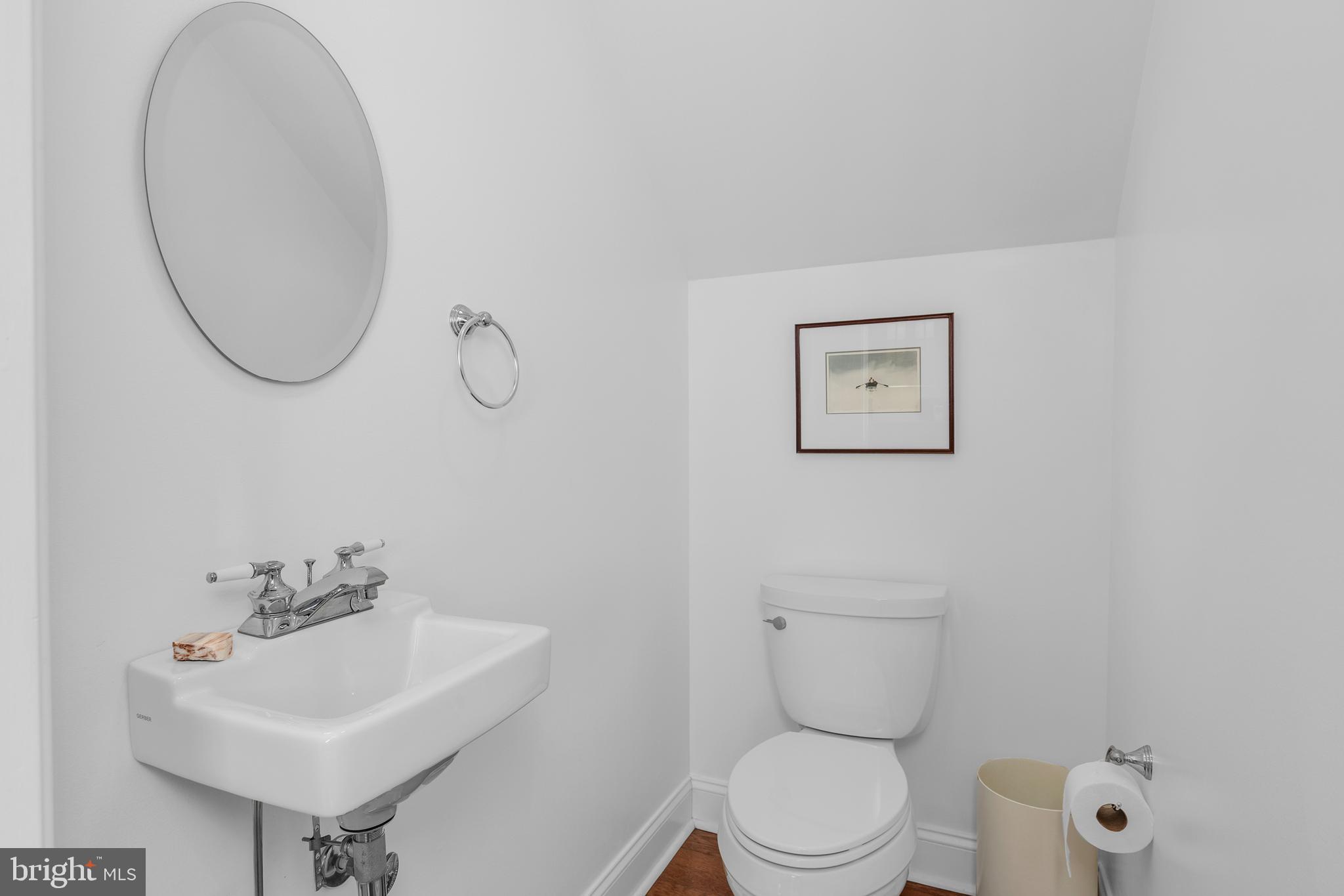 28872 Jasper Lane Easton, MD 21601 - Photo 28 of 38 a bathroom with a toilet a sink and a mirror