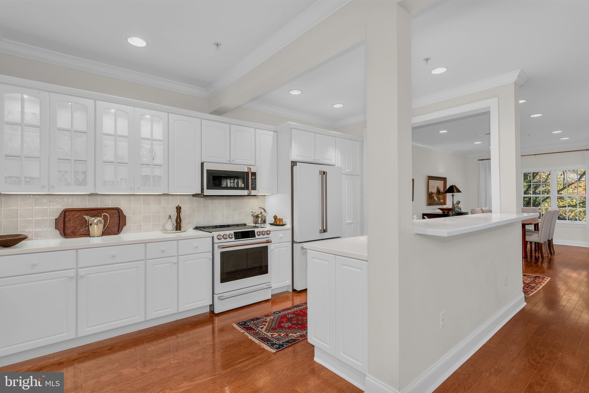 28872 Jasper Lane Easton, MD 21601 - Photo 5 of 38 a kitchen with white cabinets and stainless steel appliances
