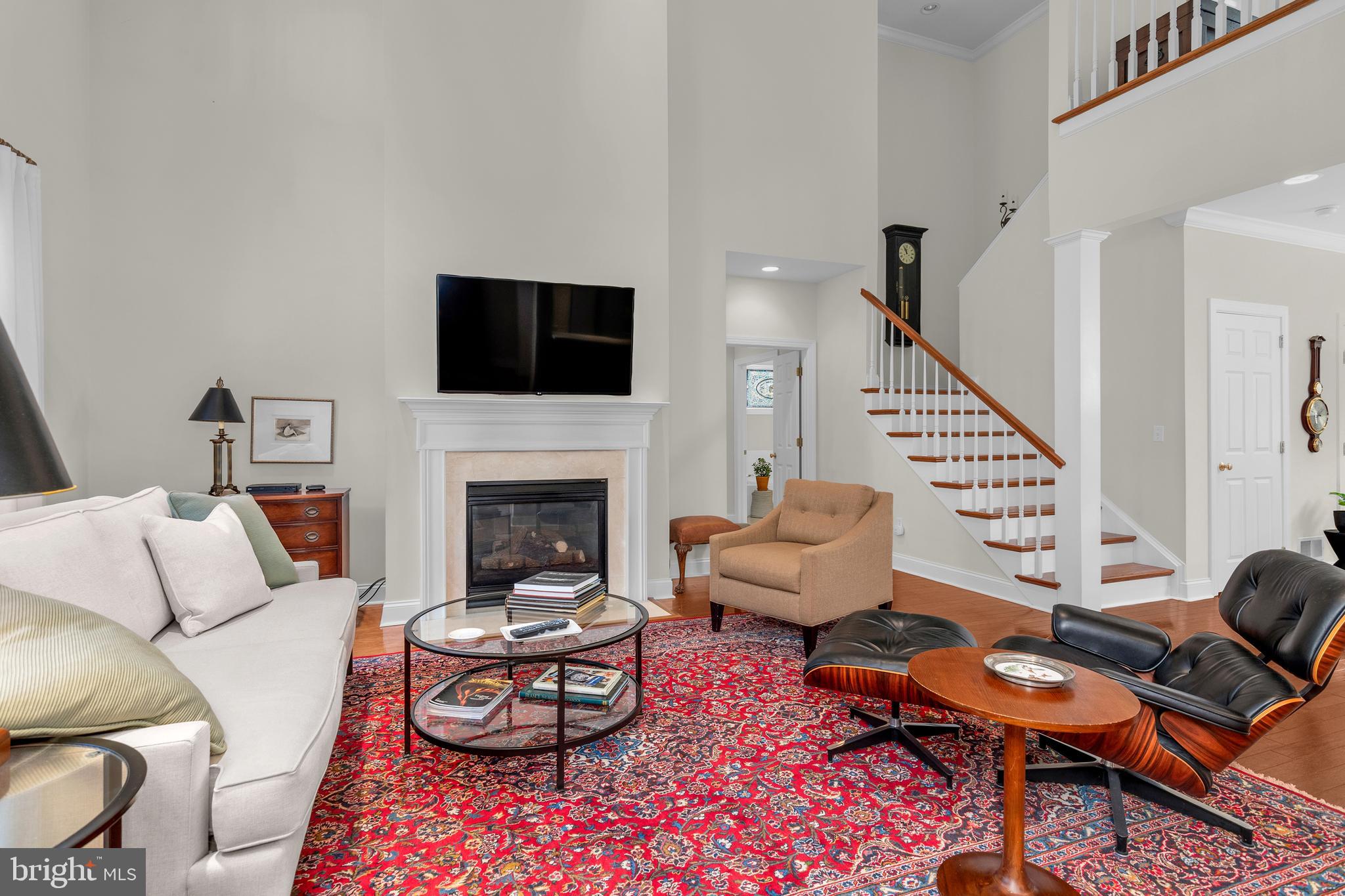 28872 Jasper Lane Easton, MD 21601 - Photo 6 of 38 a living room with furniture a fireplace and a flat screen tv