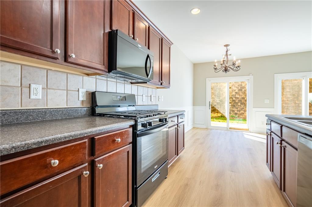 2245 Leicester Way Southeast Atlanta, GA 30316 - Photo 13 of 29 a kitchen with stainless steel appliances granite countertop a sink stove and cabinets