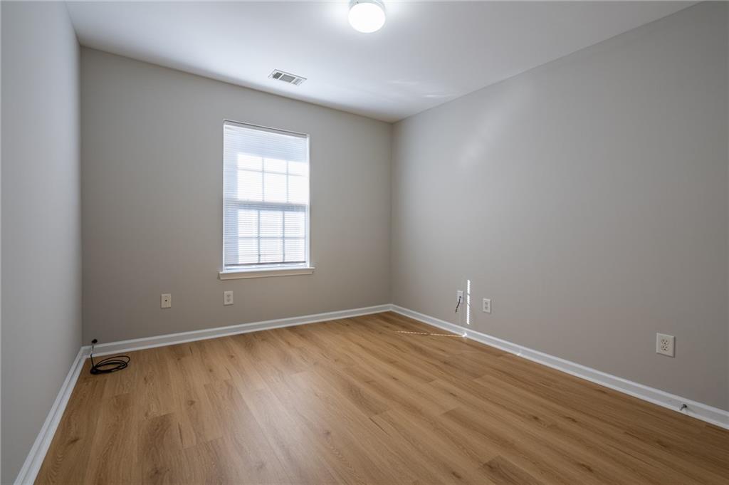 2245 Leicester Way Southeast Atlanta, GA 30316 - Photo 14 of 29 an empty room with wooden floor and windows
