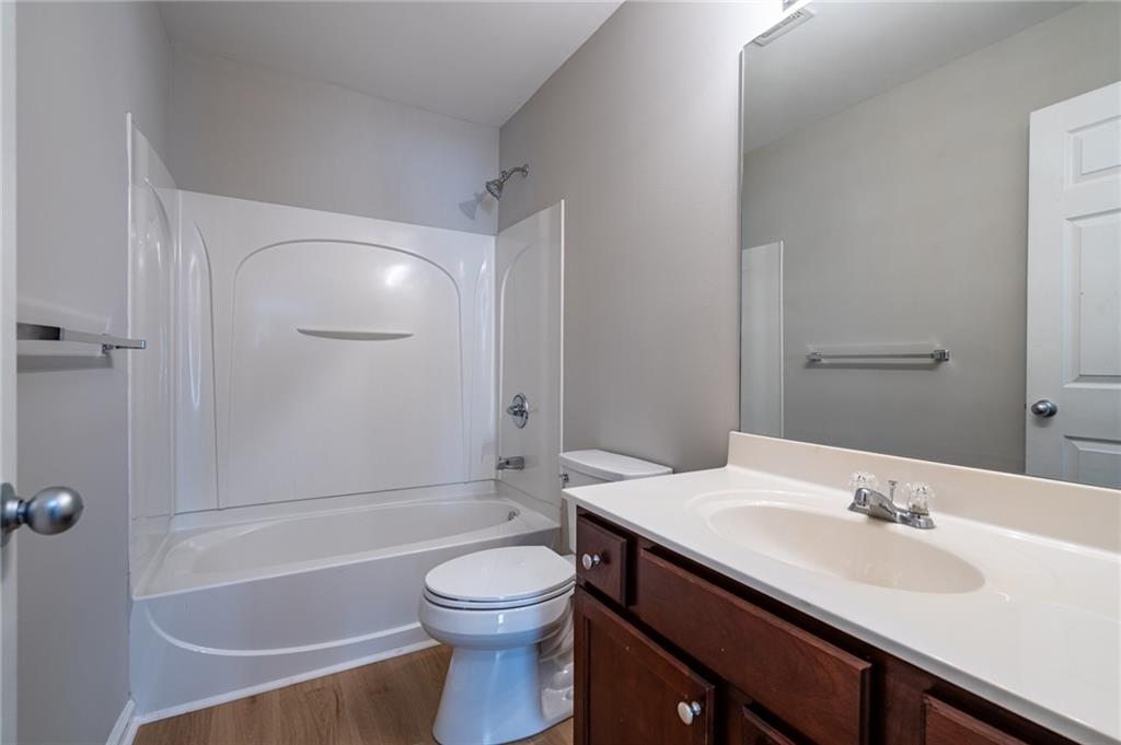 2245 Leicester Way Southeast Atlanta, GA 30316 - Photo 15 of 29 a bathroom with a bathtub shower sink vanity mirror and toilet