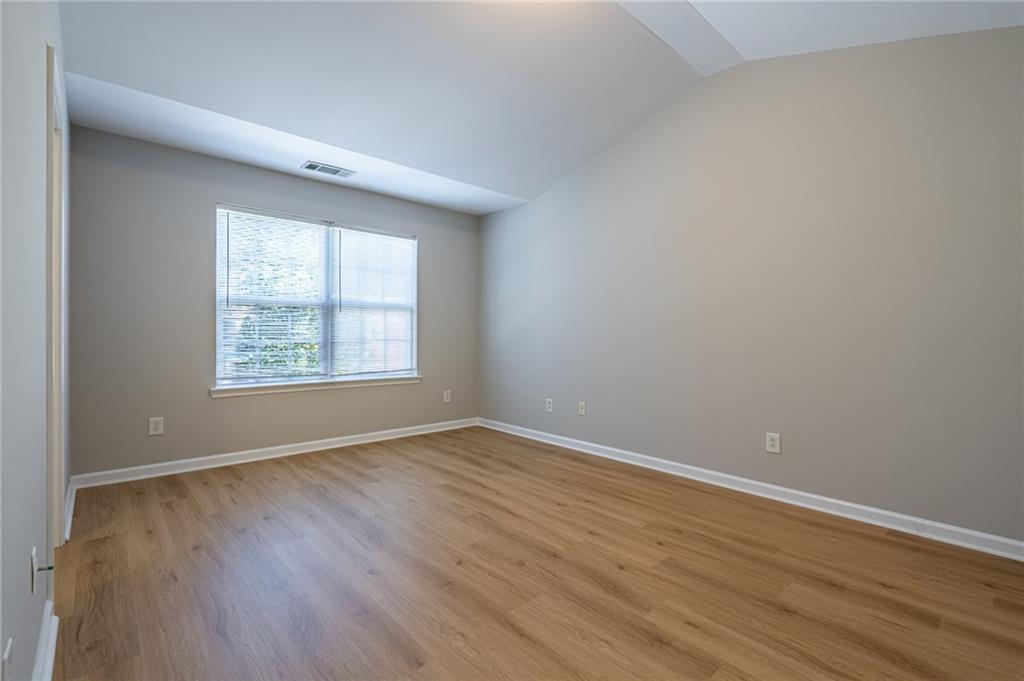 2245 Leicester Way Southeast Atlanta, GA 30316 - Photo 18 of 29 an empty room with wooden floor and windows