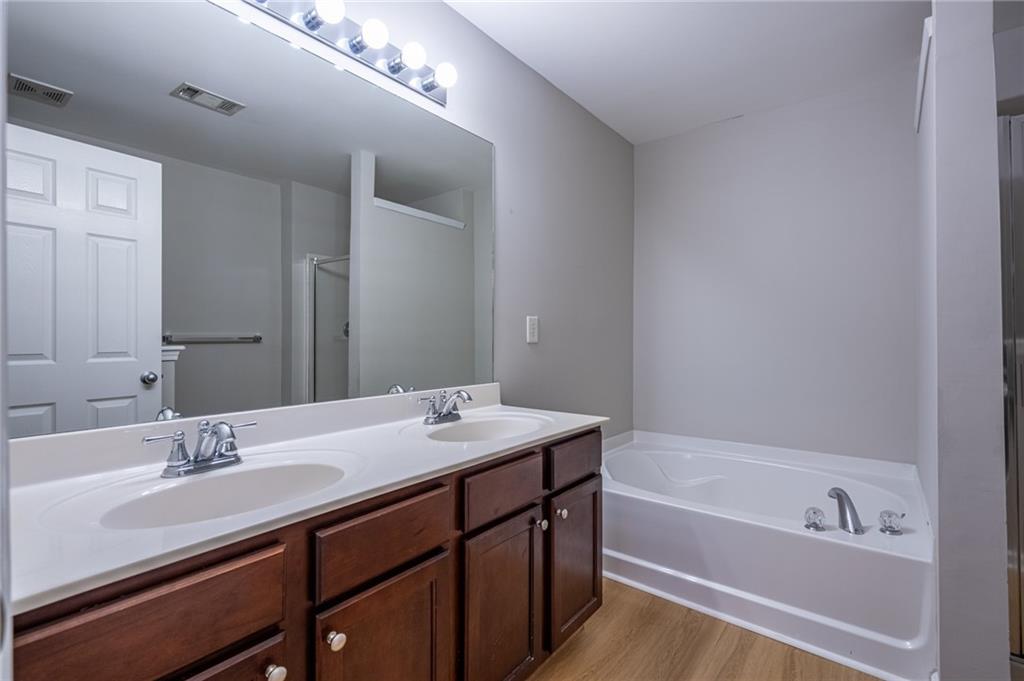 2245 Leicester Way Southeast Atlanta, GA 30316 - Photo 21 of 29 a bathroom with a tub double sink and mirror